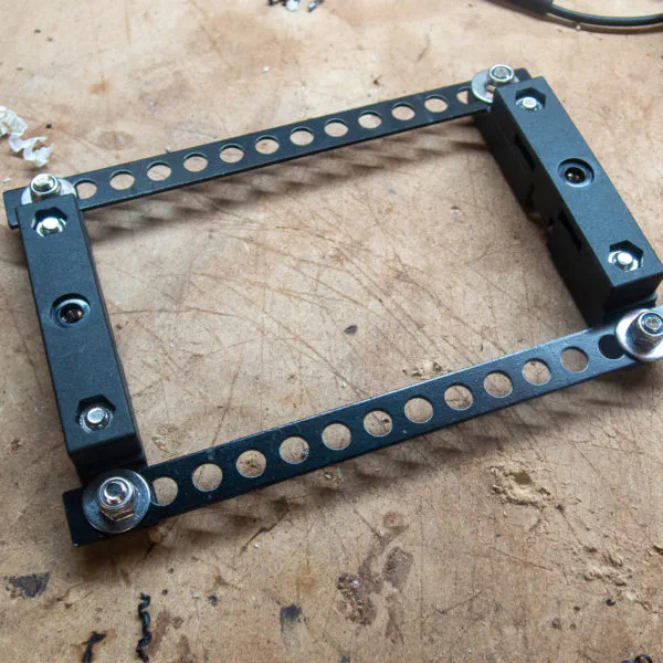 Brackets fitted to steel cross-sections to allow for zip tying/bolting to the rack.