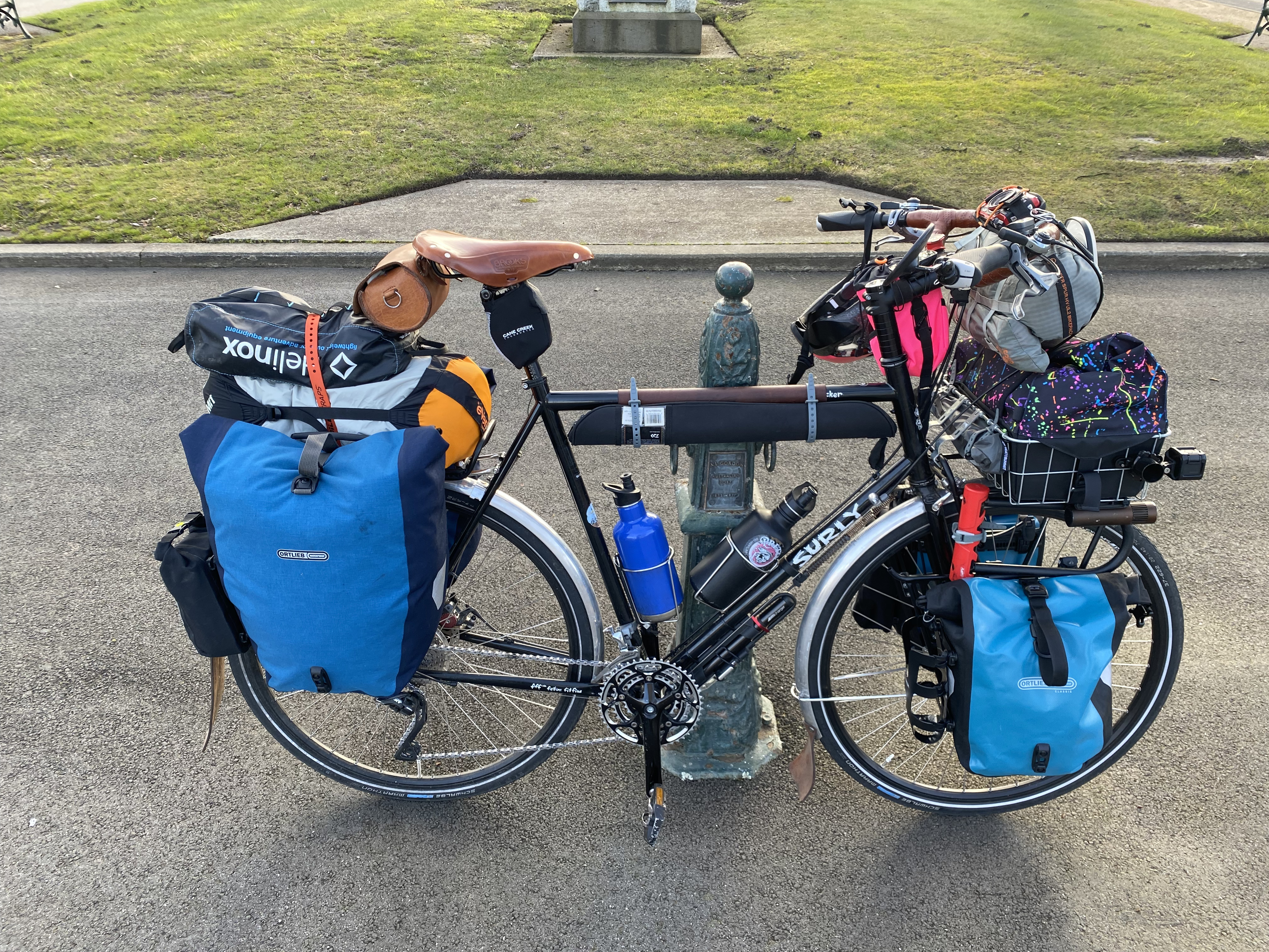 Panniers loaded front and back, with a basket &amp; bag at front, tent on the handlebars, extra blanket on the back rack between the panniers, an ultralight hiking chair strapped to the blanket, and fishing rod beneath the top tube.